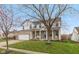 Charming two-story home with brick and vinyl exterior, covered porch, green lawn, and mature tree at 15885 Symphony Blvd, Noblesville, IN 46060