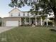 Charming two-story home with a welcoming front porch, white pillars and a well-manicured lawn at 15885 Symphony Blvd, Noblesville, IN 46060