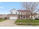 Two-story brick and vinyl home with attached two car garage, covered front porch, and well-kept lawn at 15885 Symphony Blvd, Noblesville, IN 46060