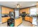 Well-lit kitchen featuring stainless steel appliances, an island, and tile flooring at 15885 Symphony Blvd, Noblesville, IN 46060