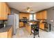 Charming kitchen with wooden cabinets, stainless steel appliances, and a central island at 15885 Symphony Blvd, Noblesville, IN 46060