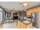 Open kitchen layout offering an island, stainless steel refrigerator, and seamless connection to the living area at 15885 Symphony Blvd, Noblesville, IN 46060