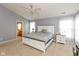 This spacious main bedroom features grey walls, carpet, a traditional-style white bed, and an ensuite bathroom at 15885 Symphony Blvd, Noblesville, IN 46060