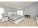 This spacious main bedroom has grey walls, carpet flooring, and a traditional-style white bed and ceiling fan at 15885 Symphony Blvd, Noblesville, IN 46060