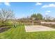 Backyard playground with swings, slide, and basketball court on a green lawn at 15885 Symphony Blvd, Noblesville, IN 46060