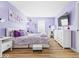 Comfortable bedroom with a light purple color scheme features a large window for natural light at 1683 Sweetwater Ln, Greenfield, IN 46140