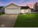 Charming one-story home featuring an attached garage and well-maintained front yard at 1683 Sweetwater Ln, Greenfield, IN 46140