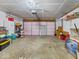 Spacious garage with pink door has lots of room for storage and a large work area at 1683 Sweetwater Ln, Greenfield, IN 46140