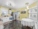 Bright kitchen features stainless appliances, dark tile floors, and fun, modern light fixtures at 1683 Sweetwater Ln, Greenfield, IN 46140