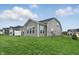 Well-maintained backyard with lush green grass, complemented by a gray house at 16955 Cole Evans Dr, Noblesville, IN 46060