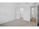 Neutral carpet and crisp white walls provide an airy atmosphere to this bright, minimalist bedroom at 16955 Cole Evans Dr, Noblesville, IN 46060