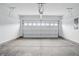 Clean, empty two-car garage featuring a freshly painted interior and sealed concrete floor at 16955 Cole Evans Dr, Noblesville, IN 46060