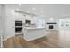 Bright and modern kitchen featuring white cabinets, a center island, and stainless steel appliances at 16955 Cole Evans Dr, Noblesville, IN 46060