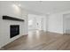 Open living room with a fireplace, hardwood floors and open floor plan at 16955 Cole Evans Dr, Noblesville, IN 46060