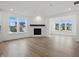 Bright living room with hardwood floors, fireplace, large windows, and plenty of natural light at 16955 Cole Evans Dr, Noblesville, IN 46060