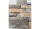 Close up of a variety of neutral-colored stone and siding samples at 16955 Cole Evans Dr, Noblesville, IN 46060