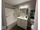Bright bathroom featuring a tub/shower combo and a white vanity with a modern sink at 2406 E 10Th St, Anderson, IN 46012