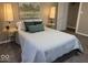 Bedroom featuring a full bed, accent pillows, carpet, and warm lighting at 2406 E 10Th St, Anderson, IN 46012