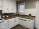 Well-lit kitchen with white cabinets, double sink, and countertop space at 2406 E 10Th St, Anderson, IN 46012