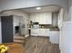 Bright kitchen features white cabinets, stainless steel refrigerator, and modern appliances at 2406 E 10Th St, Anderson, IN 46012