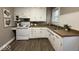 Corner view of a kitchen with modern white cabinets and countertop with a window above the sink at 2406 E 10Th St, Anderson, IN 46012