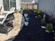 Cozy backyard featuring a patio, lounge chairs, and a landscaped garden with mulch and various potted plants at 2460 Collins Dr, Westfield, IN 46074