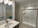 Bathroom featuring glass shower, gray cabinets and quartz countertop at 2460 Collins Dr, Westfield, IN 46074