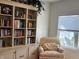Living room featuring a bookshelf, chair, and window with blinds at 2460 Collins Dr, Westfield, IN 46074