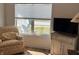 Living room featuring a comfortable chair, view of outdoors, and small cabinet at 2460 Collins Dr, Westfield, IN 46074