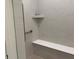 Modern shower features elegant tile, a bench, and a convenient shelf at 2460 Collins Dr, Westfield, IN 46074