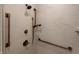Shower showcasing modern bronze fixtures, white tiled walls, and a hand held shower at 2460 Collins Dr, Westfield, IN 46074
