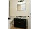 Updated bathroom with a dark vanity, granite countertop, and modern fixtures at 2750 Kristen E Dr, Indianapolis, IN 46218