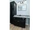 Modern bathroom featuring black vanity with granite countertops and a stylish mirror at 2750 Kristen E Dr, Indianapolis, IN 46218