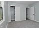 Bedroom with plush gray carpet, closet, and a bright window at 2750 Kristen E Dr, Indianapolis, IN 46218
