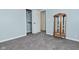Cozy bedroom with gray carpet, a display cabinet and a convenient closet at 2750 Kristen E Dr, Indianapolis, IN 46218