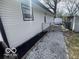 Exterior view of the home with gravel walkway and white fence at 2750 Kristen E Dr, Indianapolis, IN 46218