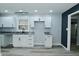 Modern kitchen featuring white cabinets, gray countertops, and stainless steel sink and faucet at 2750 Kristen E Dr, Indianapolis, IN 46218