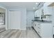 Clean and modern kitchen with white cabinets, gray countertops, and new laminate flooring at 2750 Kristen E Dr, Indianapolis, IN 46218