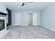 Open living room featuring plush gray carpeting and a cozy fireplace at 2750 Kristen E Dr, Indianapolis, IN 46218