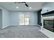 Cozy living room featuring a fireplace, sliding glass doors, and a modern accent wall at 2750 Kristen E Dr, Indianapolis, IN 46218