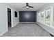 Open-concept living room featuring large windows, stylish accent wall, and neutral gray carpeting at 2750 Kristen E Dr, Indianapolis, IN 46218