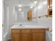 Bathroom features wood vanity, large mirror, decorative lighting, and ample countertop space at 2770 Two Worlds Dr, Columbus, IN 47201