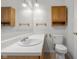 Bathroom features wood vanity, bright countertop, sleek white toilet, and modern light fixtures at 2770 Two Worlds Dr, Columbus, IN 47201