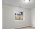Empty bedroom features neutral paint, carpeted floors, bright light fixture, and view to the backyard at 2770 Two Worlds Dr, Columbus, IN 47201