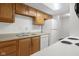 Bright kitchen with wood cabinets, white appliances, and tiled backsplash at 2770 Two Worlds Dr, Columbus, IN 47201