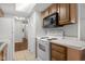 Well-lit kitchen featuring white appliances and wood cabinets at 2770 Two Worlds Dr, Columbus, IN 47201