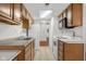 Kitchen with skylight, wood cabinets, white appliances, and tile floors at 2770 Two Worlds Dr, Columbus, IN 47201