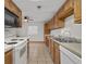 Kitchen featuring wood cabinets and white appliances at 2770 Two Worlds Dr, Columbus, IN 47201