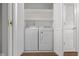 Laundry room features new washer and dryer, ample shelving, and modern doors at 2770 Two Worlds Dr, Columbus, IN 47201