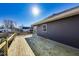 A new wood back deck is ready for entertaining in this home with a sliding glass door and dark gray siding at 3006 W 10Th St, Indianapolis, IN 46222